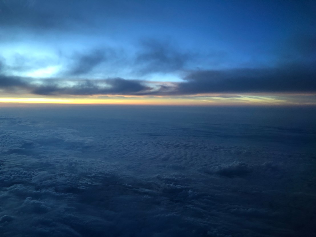 Sunset_over_clouds_Pacific_Ocean_2019